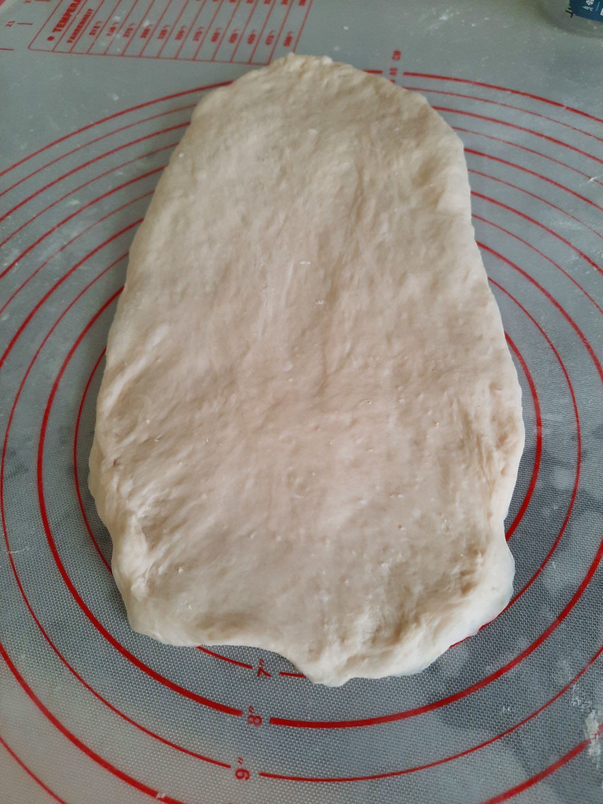 After dusting with hand flour, roll the dough into  the shape and Slightly push the dough into a slender shape