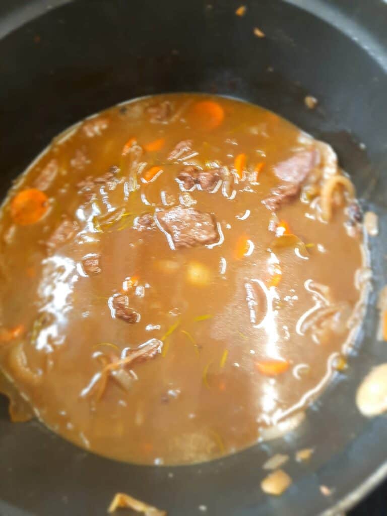 eturn the meat to the pan together with the third of the red wine and the veal stock (or meat stock cube)
simmer gently for 1 hour or until meat is tender and wine has reduced to a sauce consistency