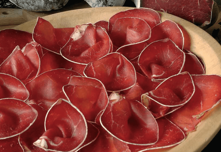 Bresaola is an Italian cured meat that is sliced thin and served chilled or at room temperature