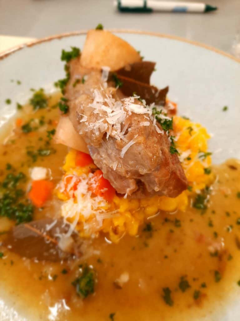 After the ossobuco and risotto are finished, they can be served on a plate for guests to enjoy