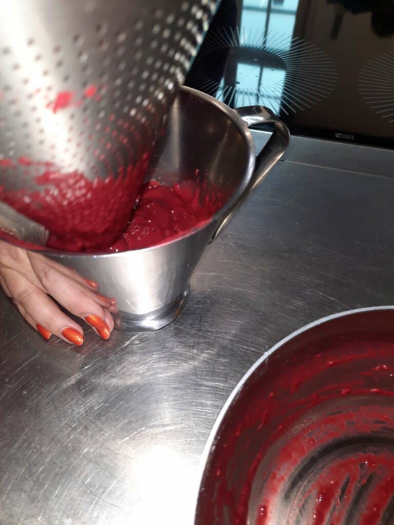 sieve the raspberry puree so that the seeds remain in the sieve